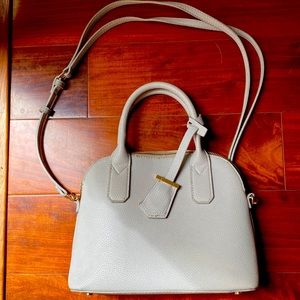 Grey crossbody purse, removable straps, interior includes 3 pockets